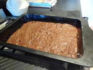 Spread out in to the greased baking tray and level the top
