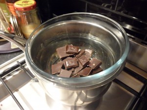 Meanwhile melt some chocolate in a glass bowl over simmering water.