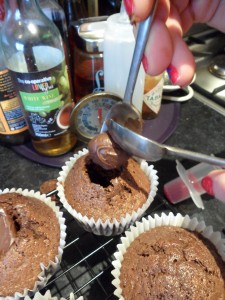 Carefully scoop about 1/2tsp of the choc spread in to each hole...